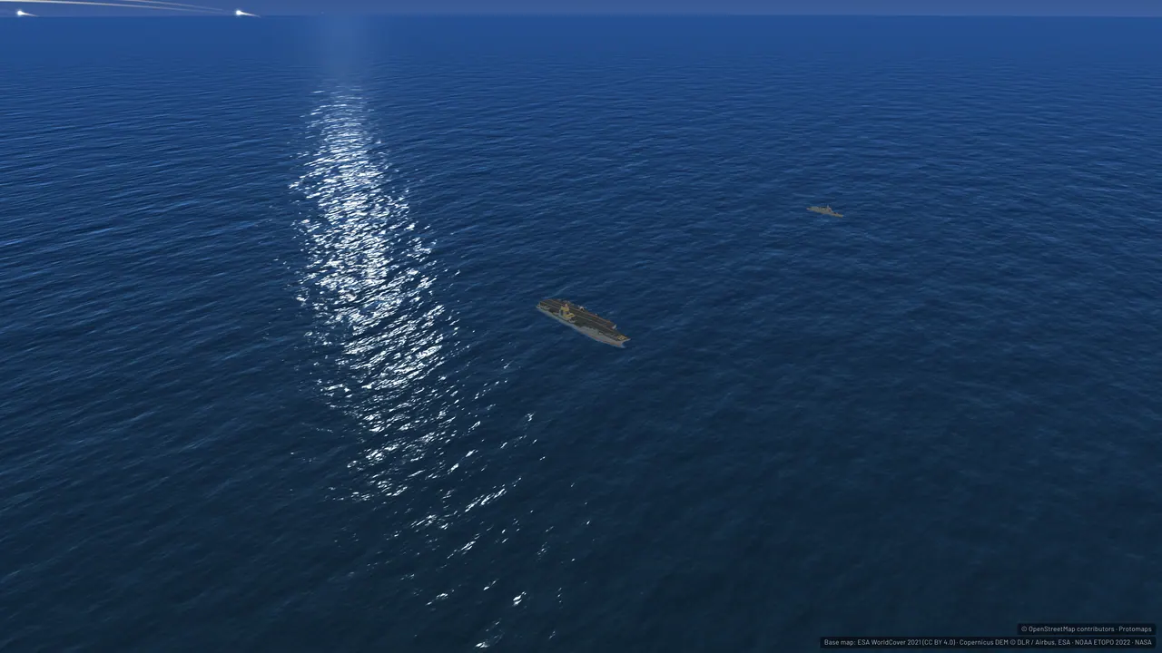 A carrier group under a sun glint on dark water.